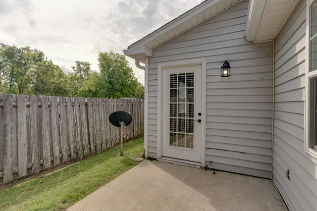 a view of a backyard with wooden fence