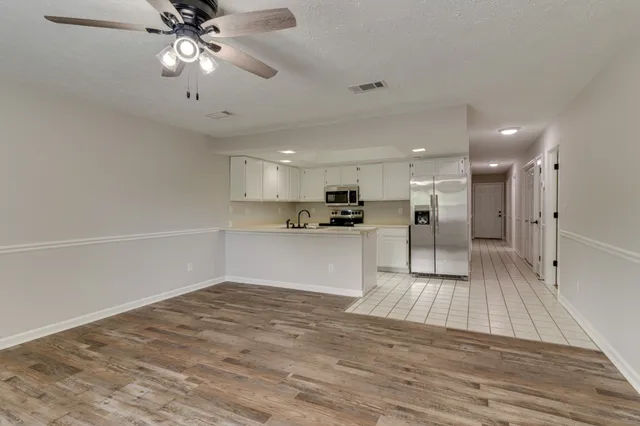 a view of kitchen with cabinets and wooden floor