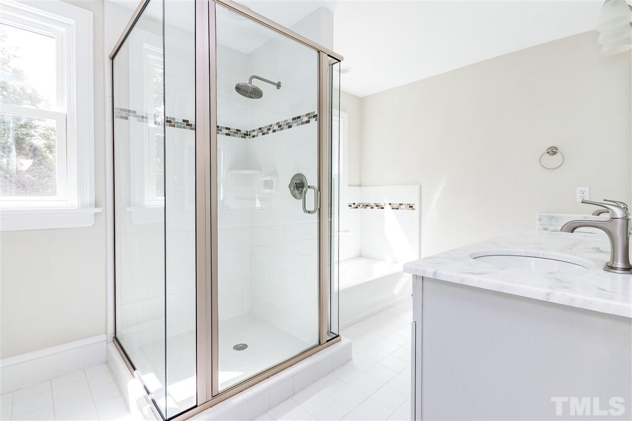 2513 Stafford Avenue Raleigh, NC 27607 - Photo 22 of 30 a bathroom with a granite countertop shower mirror and a sink