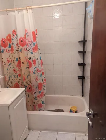 a bathroom with a bathtub and shower