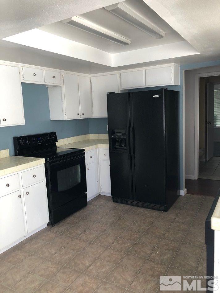 1298 Conway Lane Reno, NV 89503 - Photo 19 of 27 a kitchen with a refrigerator and cabinets