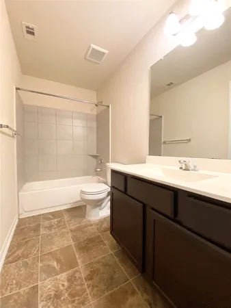 a bathroom with a bathtub sink mirror and toilet