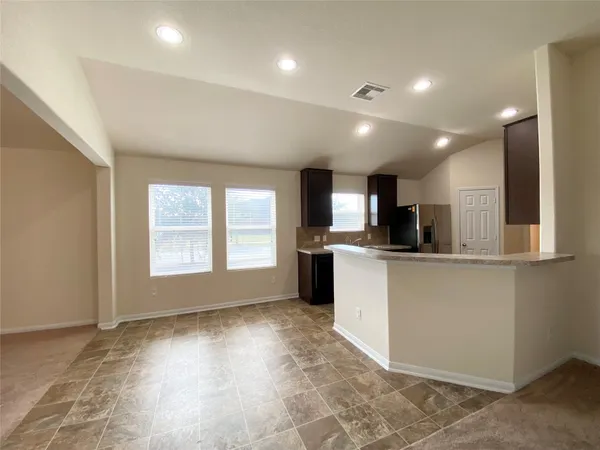 a view of kitchen with stainless steel appliances refrigerator oven and cabinets
