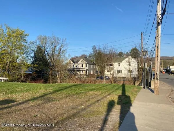 a view of a street with a building in the background