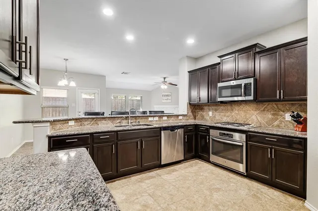 a large kitchen with granite countertop lots of counter top space