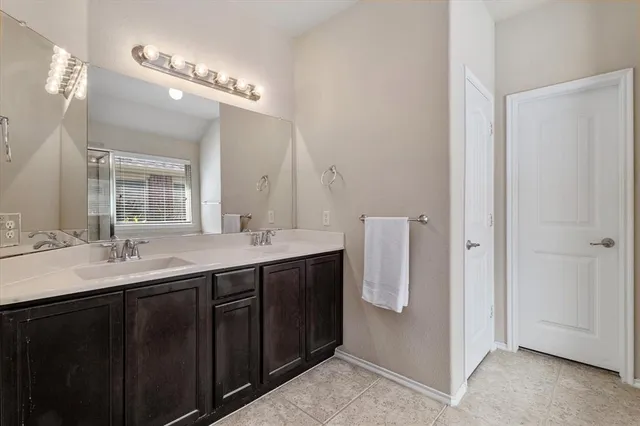 a bathroom with a double vanity sink a and mirror