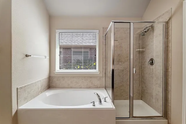 a bathroom with a bathtub and a shower