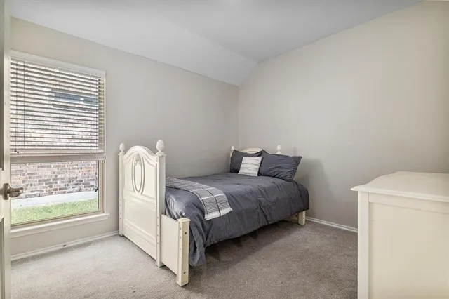 a bed room with a bed and a window