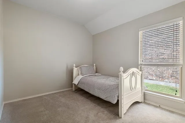 a bed sitting in a room next to a window
