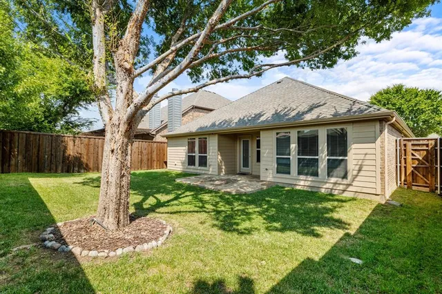 a front view of a house with a yard table and chairs
