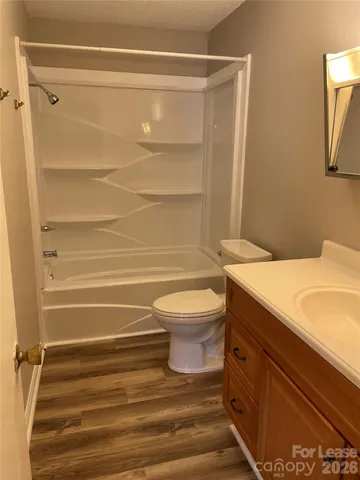 a bathroom with a granite countertop toilet and a shower