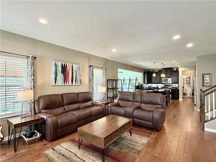 a living room with furniture and wooden floor