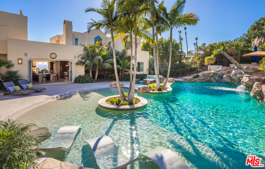 a view of backyard with swimming pool and outdoor seating