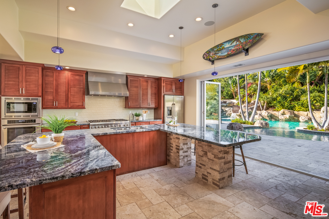 1264 Rancho Encinitas Drive Encinitas, CA 92024 - Photo 11 of 25 a kitchen with stainless steel appliances granite countertop a stove a sink and a microwave