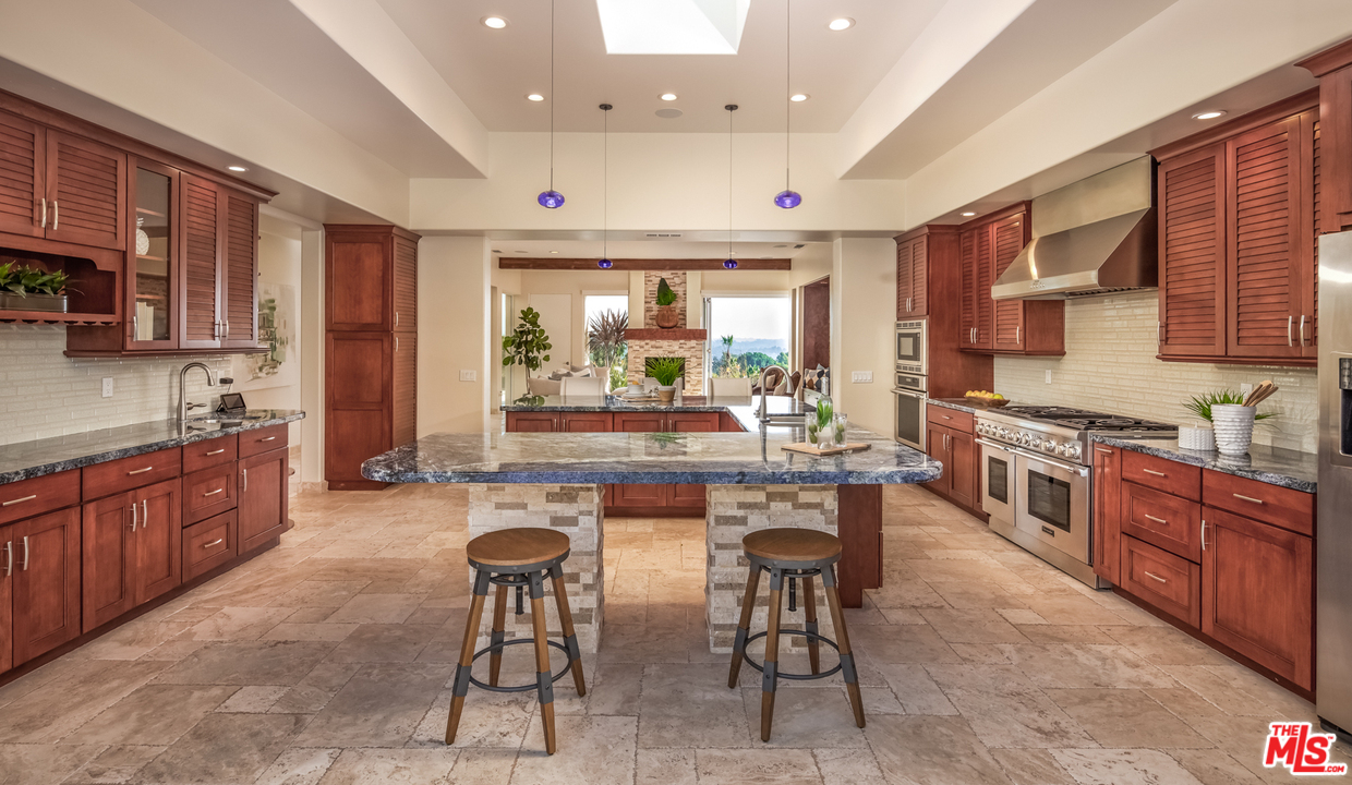 1264 Rancho Encinitas Drive Encinitas, CA 92024 - Photo 12 of 25 a kitchen with stainless steel appliances granite countertop counter space a sink and a refrigerator