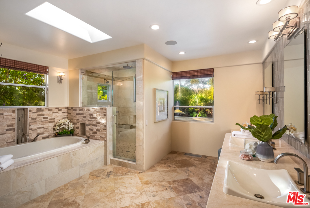 1264 Rancho Encinitas Drive Encinitas, CA 92024 - Photo 15 of 25 a bathroom with a tub shower sink and mirror