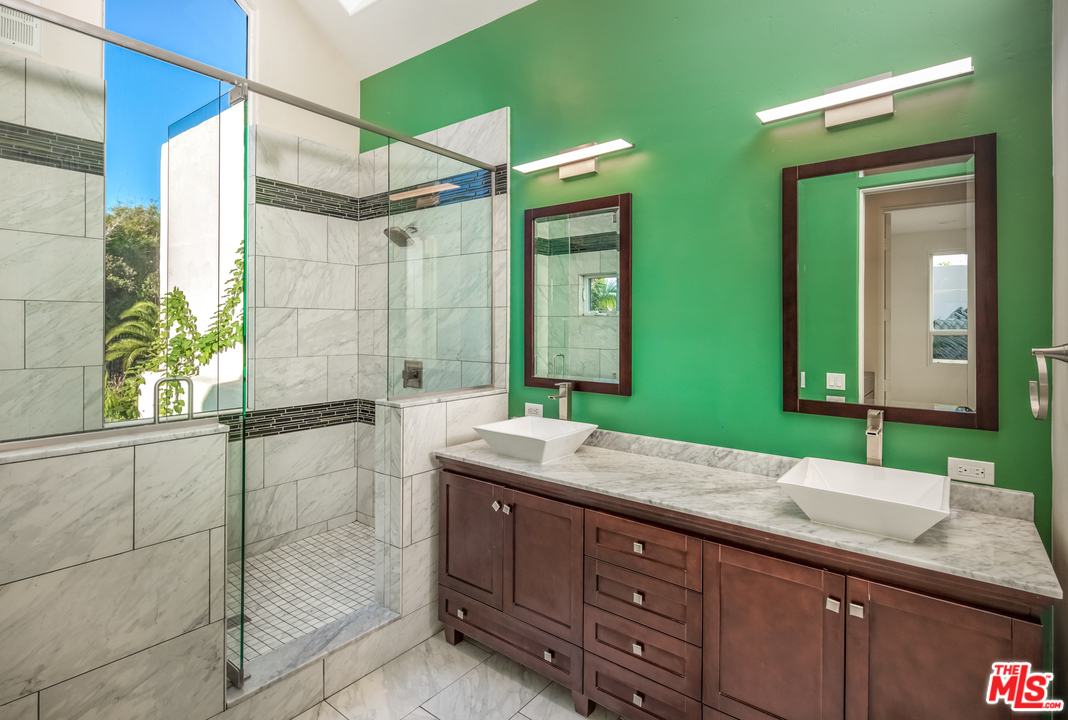1264 Rancho Encinitas Drive Encinitas, CA 92024 - Photo 17 of 25 a bathroom with a double vanity sink and a mirror