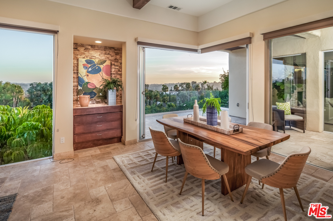 1264 Rancho Encinitas Drive Encinitas, CA 92024 - Photo 8 of 25 a view of a patio with a table and chairs