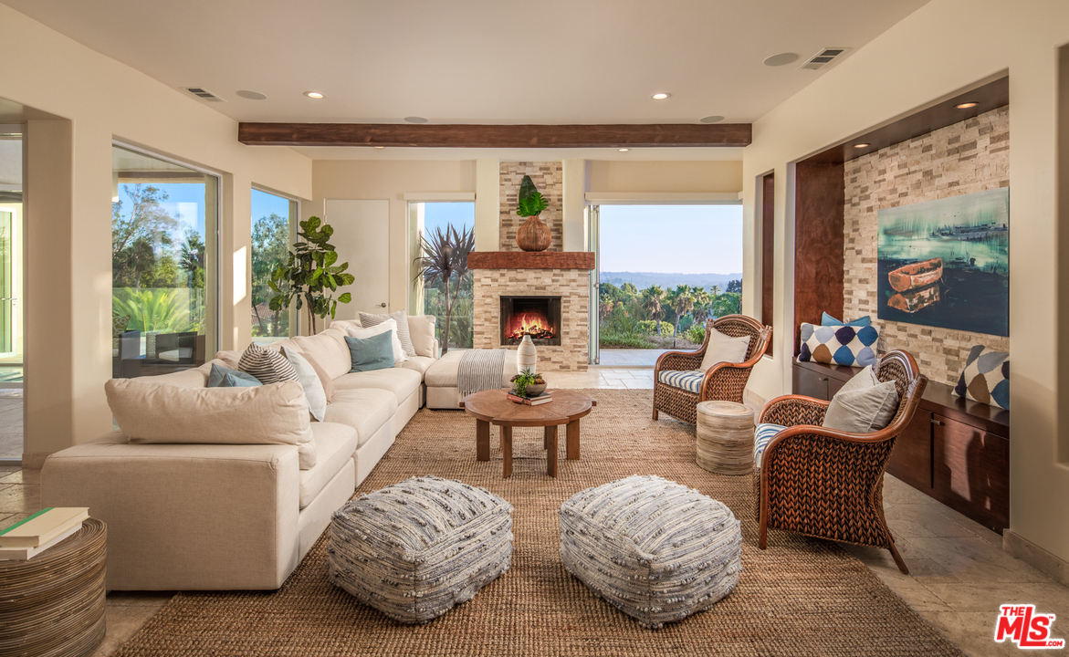 1264 Rancho Encinitas Drive Encinitas, CA 92024 - Photo 10 of 25 a living room with fireplace furniture and a large window