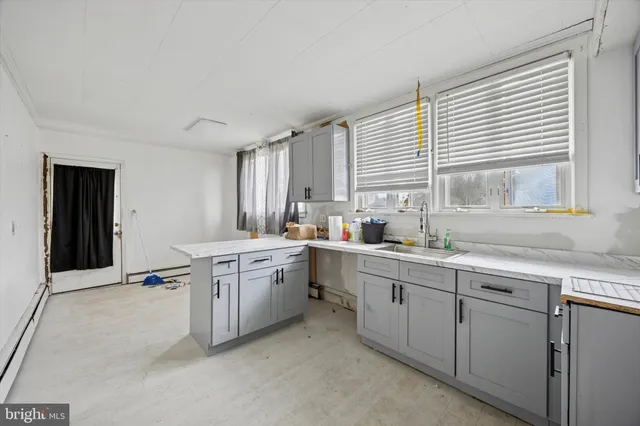 a kitchen with a sink cabinets and window