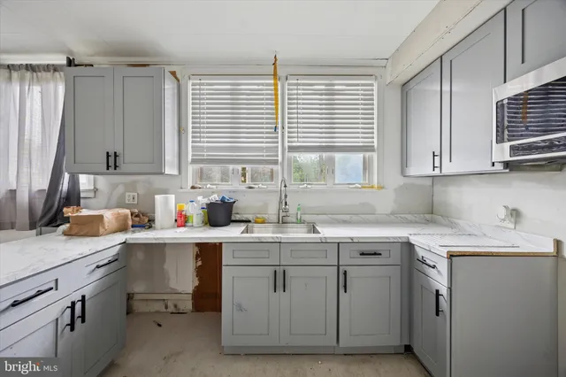 a kitchen with a stove a sink and a microwave