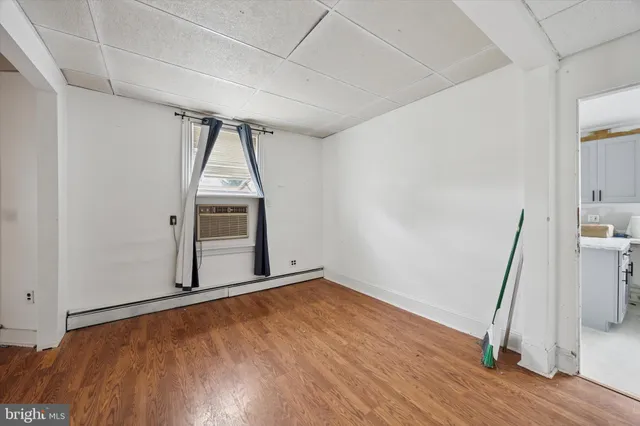 a view of empty room with wooden floor