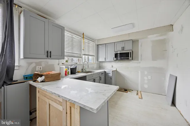a kitchen with sink cabinets and wooden floor