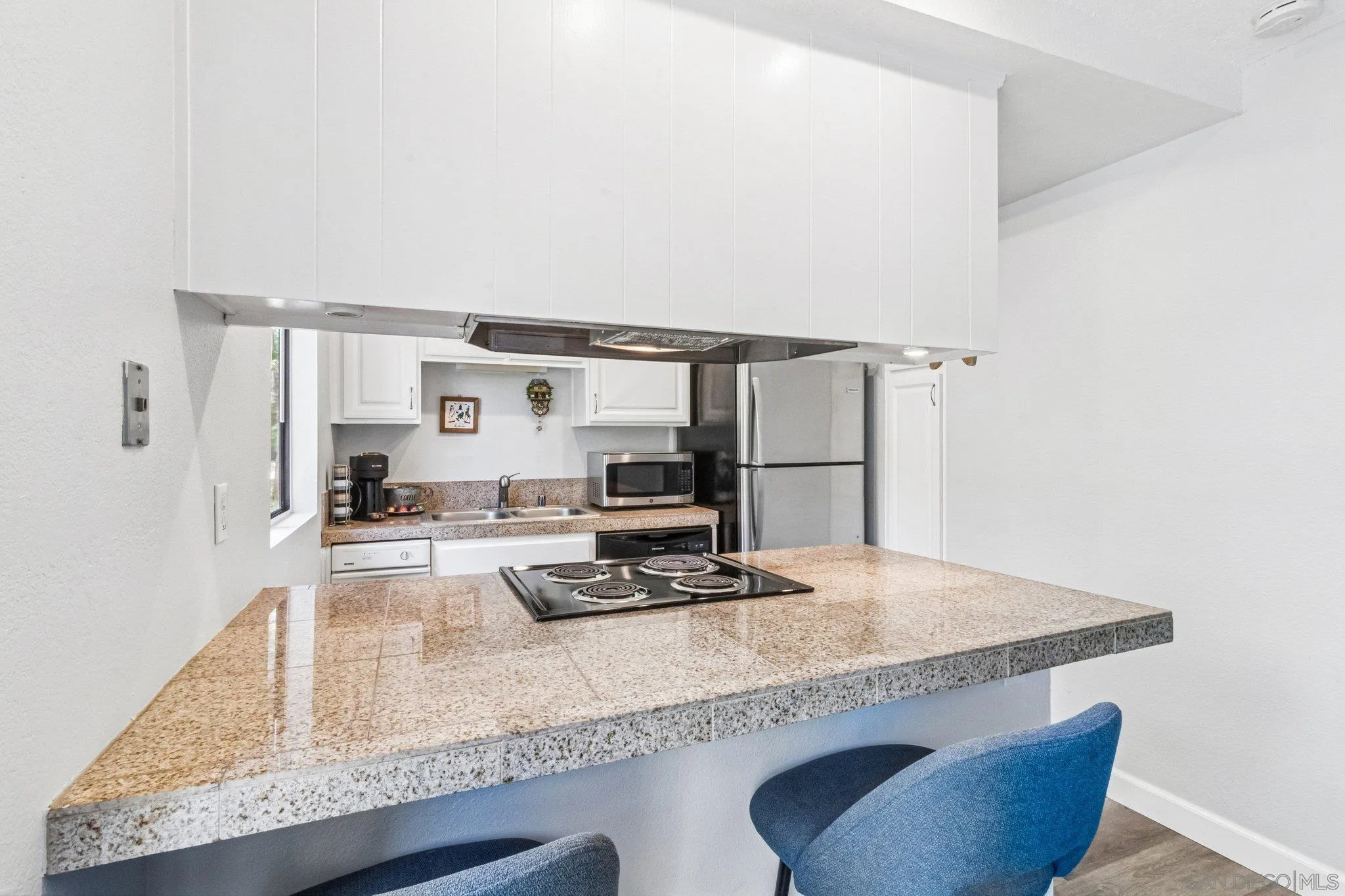 2157 Arnold Way, Unit 624 Alpine, CA 91901 - Photo 12 of 26 a kitchen with granite countertop kitchen island stainless steel appliances a sink and a counter top space
