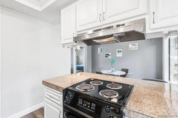 a kitchen with a stove and a refrigerator
