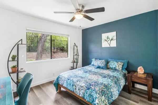 a bedroom with a bed and a chandelier