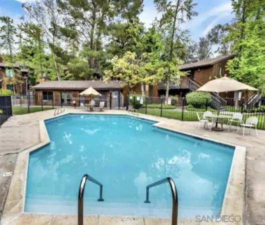 a swimming pool with outdoor seating and yard