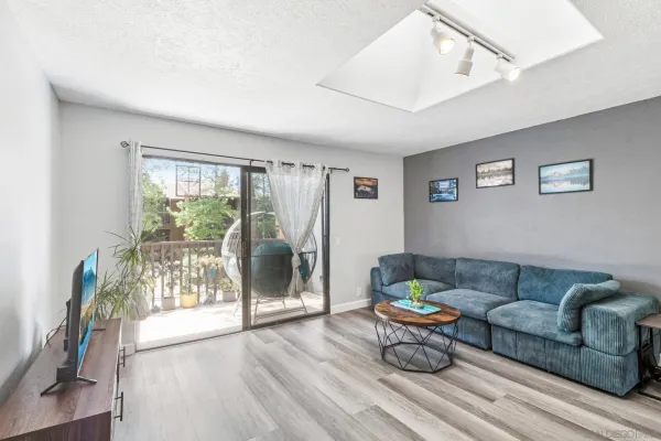 a living room with furniture and a floor to ceiling window