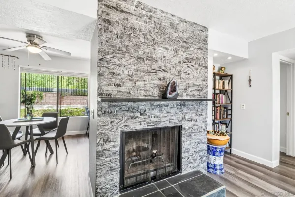 a living room with a fireplace and a floor to ceiling window