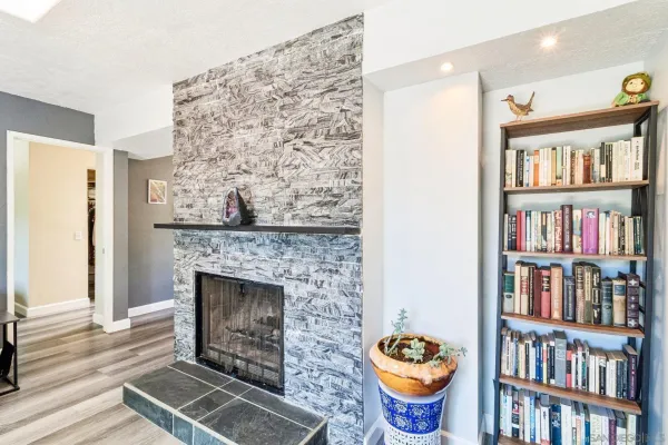 a living room with blue cabinets and a fireplace