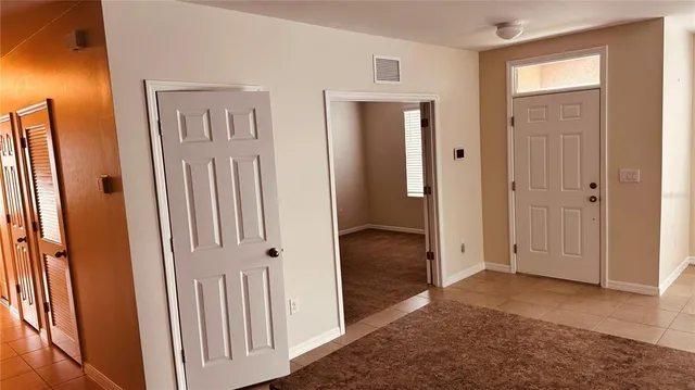a kitchen with granite countertop a stove top oven microwave and cabinets