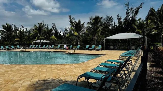 a view of a swimming pool with lounge chairs