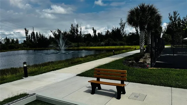 a park view with a bench in a garden