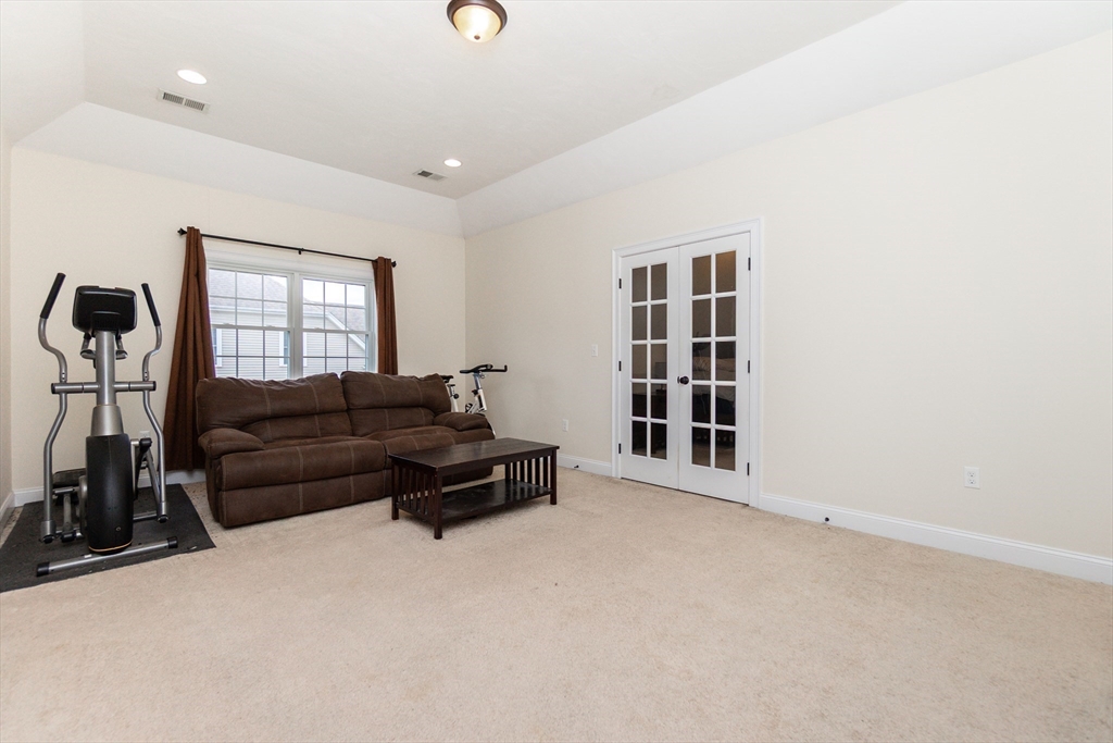 31 Whitehall Way Bellingham, MA 02019 - Photo 19 of 39 a living room with a couch and a window