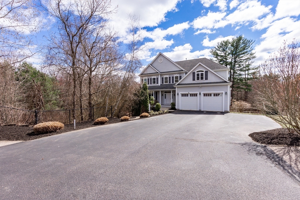 31 Whitehall Way Bellingham, MA 02019 - Photo 2 of 39 a front view of a house with a yard and garage