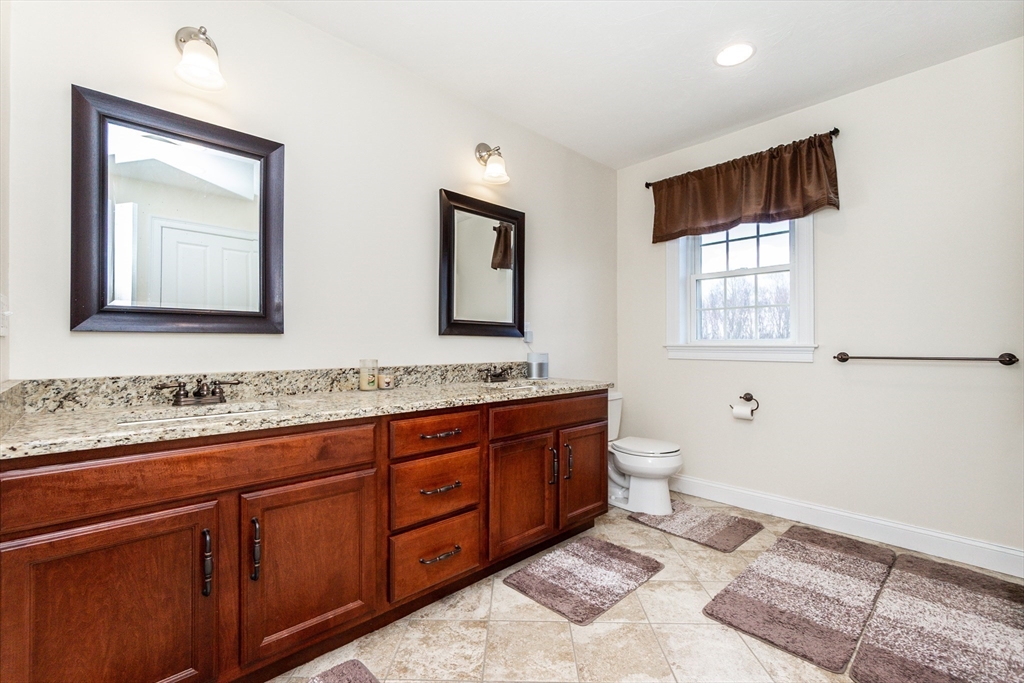 31 Whitehall Way Bellingham, MA 02019 - Photo 21 of 39 a bathroom with a toilet sink and mirror