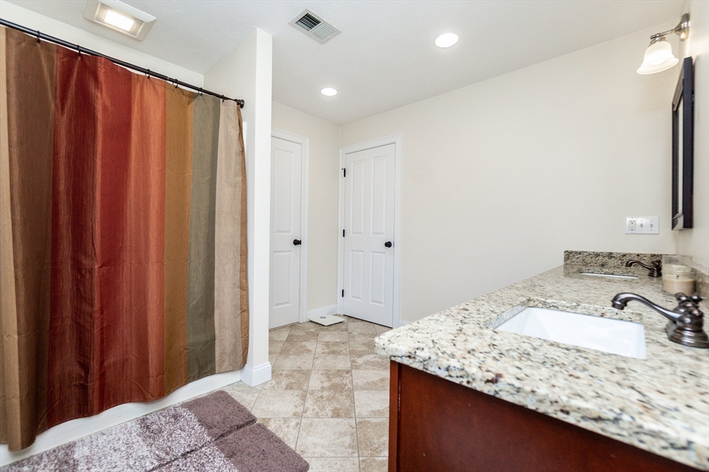31 Whitehall Way Bellingham, MA 02019 - Photo 22 of 39 a bathroom with a granite countertop sink and a mirror