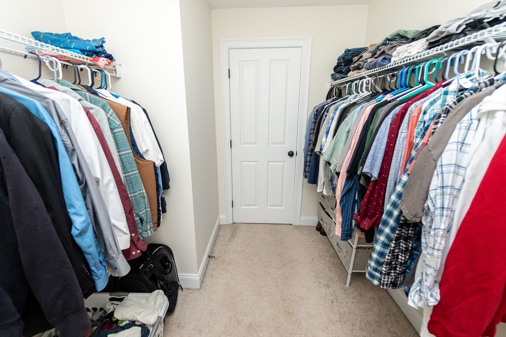 31 Whitehall Way Bellingham, MA 02019 - Photo 23 of 39 a view of walk in closet with clothes and shoes