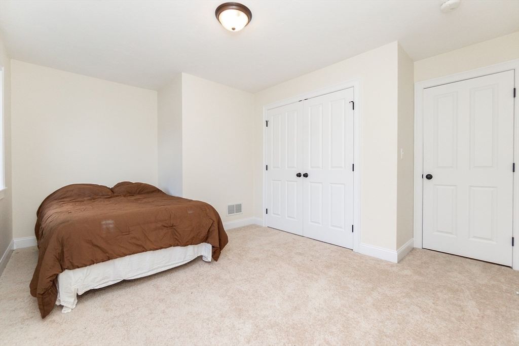 31 Whitehall Way Bellingham, MA 02019 - Photo 25 of 39 a bedroom with a bed and a night stand