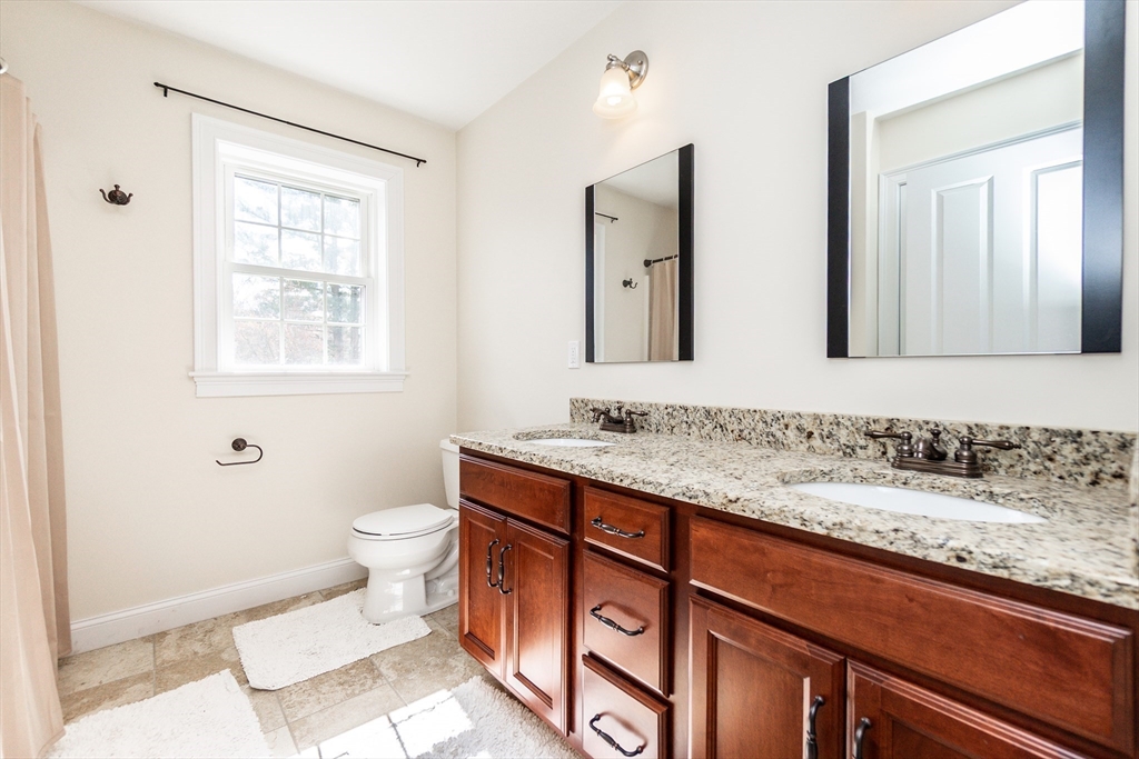 31 Whitehall Way Bellingham, MA 02019 - Photo 31 of 39 a bathroom with a granite countertop sink toilet and mirror
