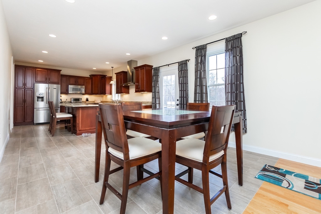 31 Whitehall Way Bellingham, MA 02019 - Photo 6 of 39 a dining room with a wooden table and chairs