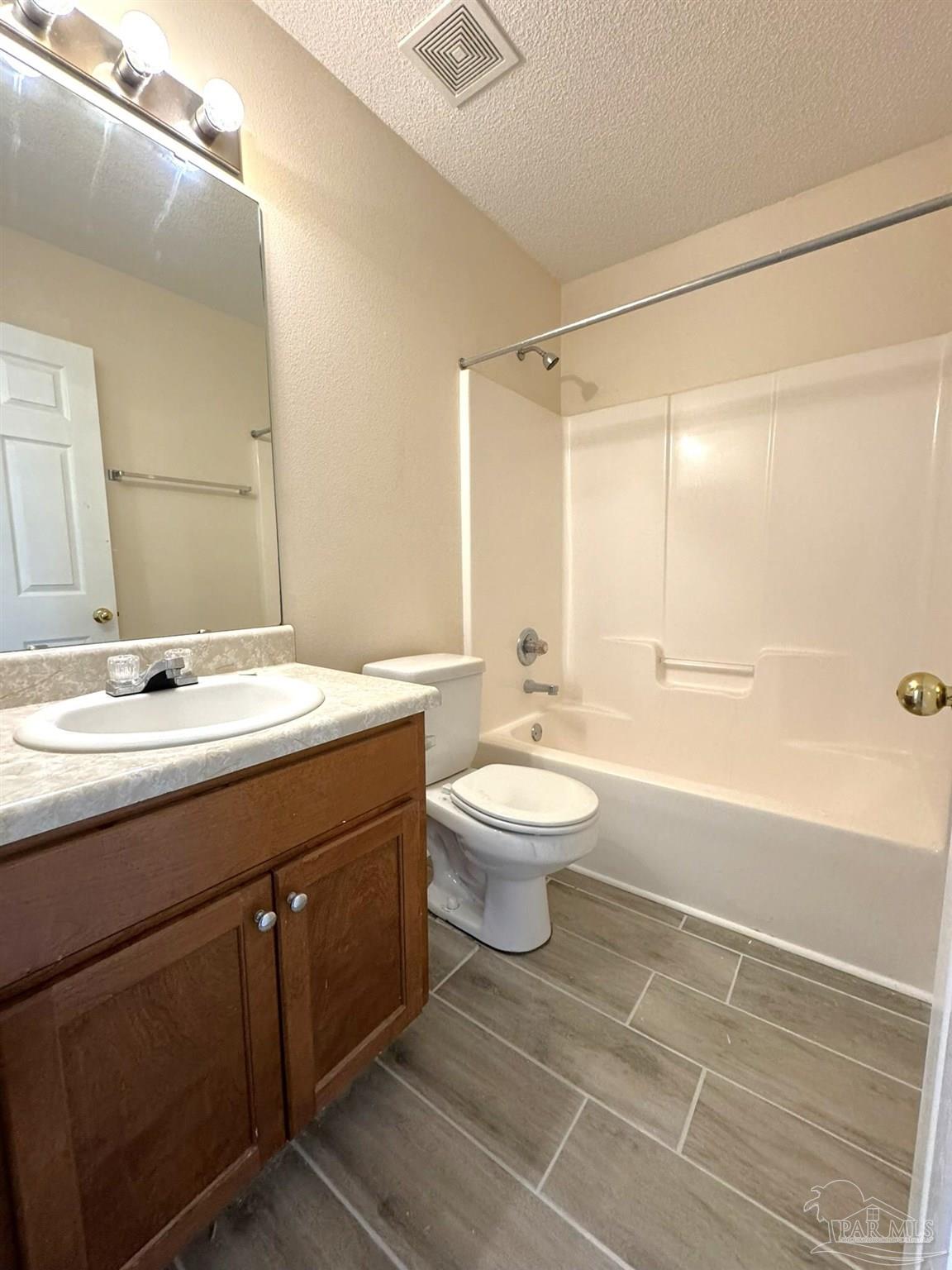 7972 Cayenne Way Pensacola, FL 32526 - Photo 7 of 11 a bathroom with a sink a toilet and shower