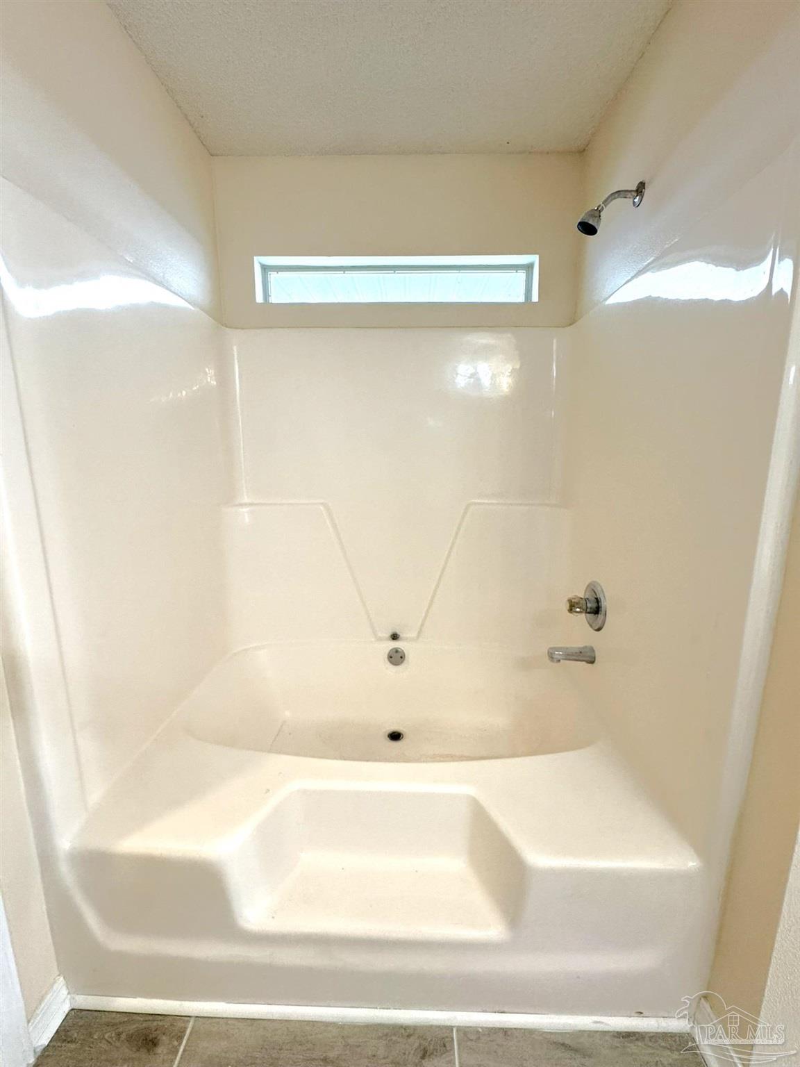 7972 Cayenne Way Pensacola, FL 32526 - Photo 9 of 11 a bathroom with a bathtub and a shower