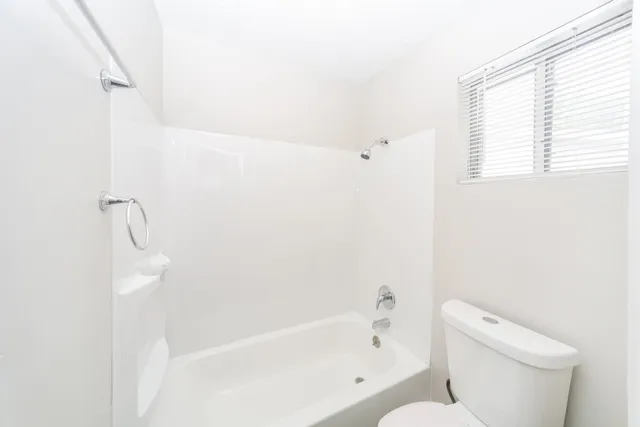 a view of a room with wooden floor and fan