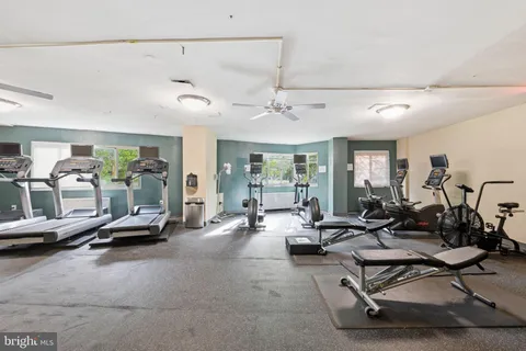 a utility room with stainless steel appliances a stove a white refrigerator and a stove top oven