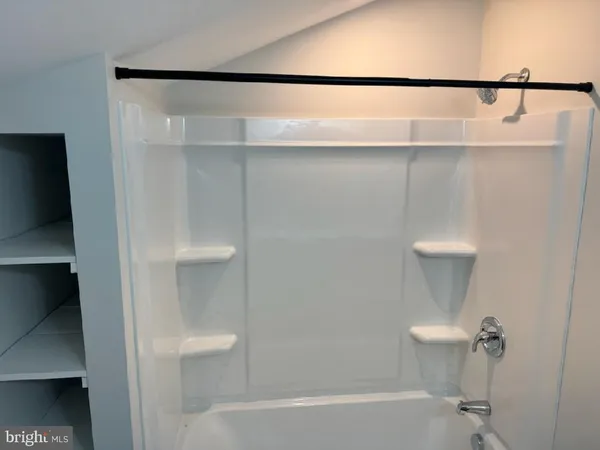 a bathroom with a shower and a toilet